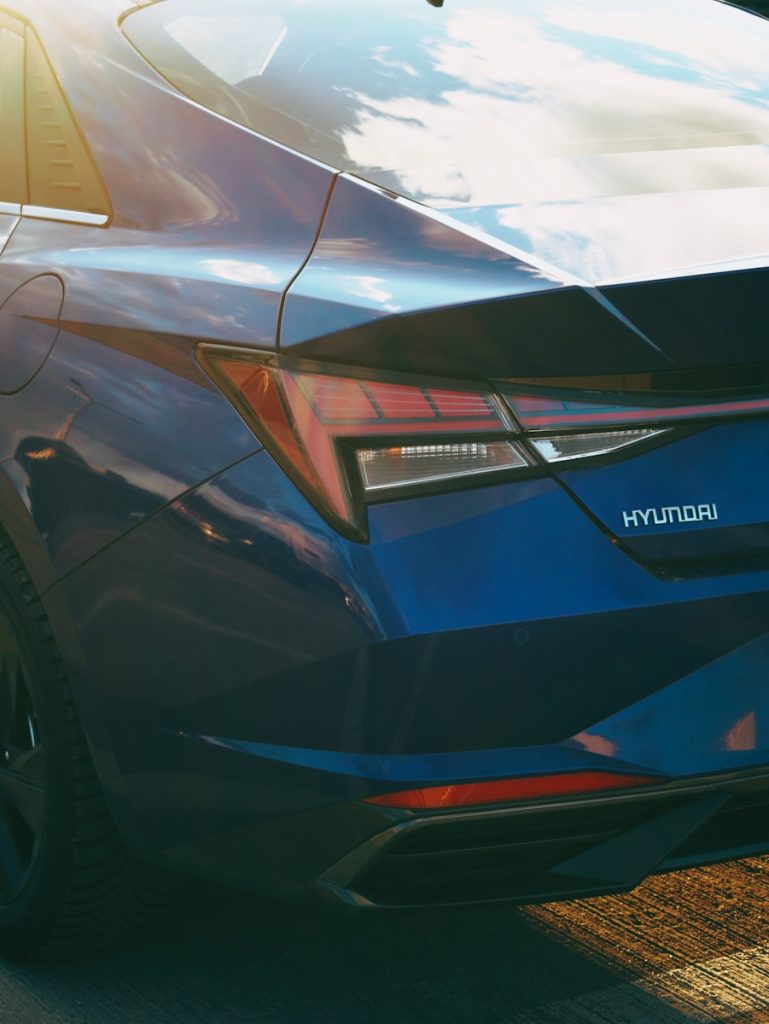 a close up of the tail end of a blue car