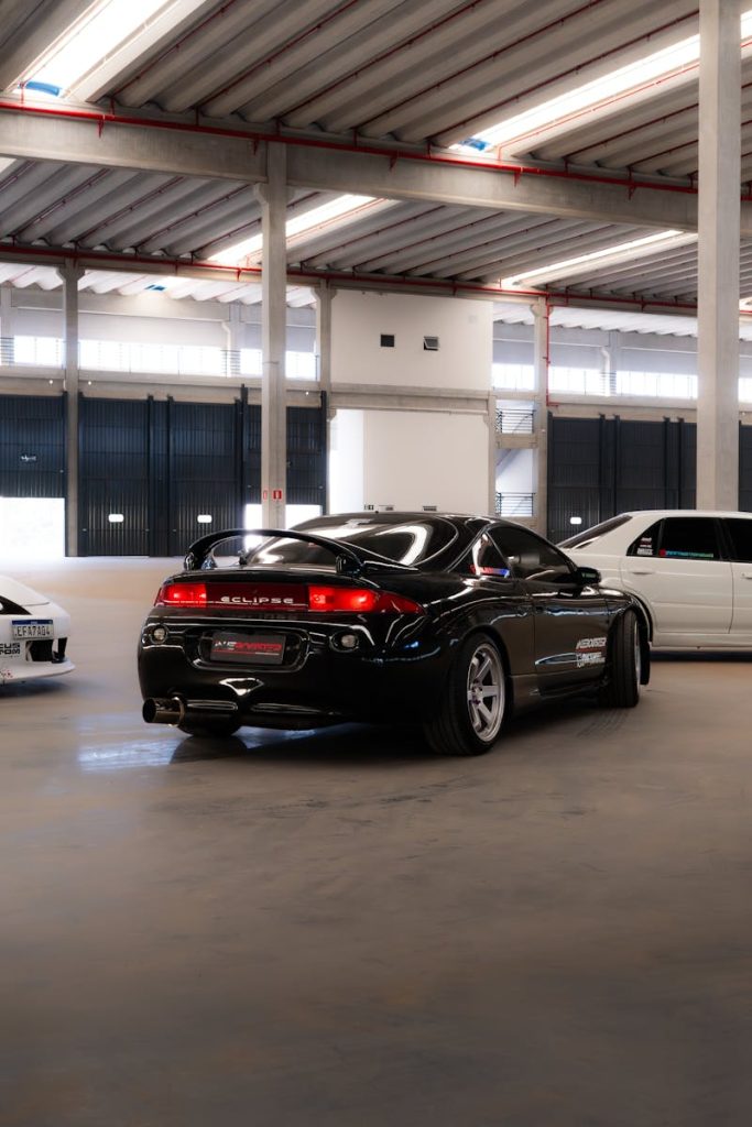 A car is parked in a garage with other cars